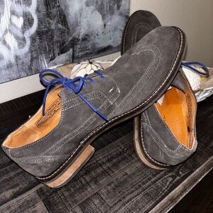This is a Vionic Bruno wingtip oxford shoe in gray suede with blue laces SS 13